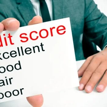 Person holding a sign showing "credit score" with "excellent" checked off.