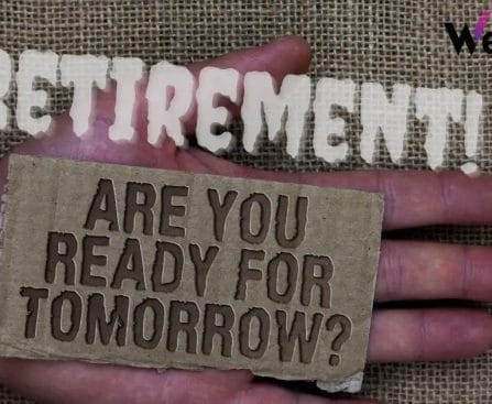A hand holding a cardboard sign saying "ARE YOU READY FOR TOMORROW?" with "RETIREMENT" above in cut-out letters.